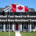 ​​A home in the background, a canadian flag on the house - What you need to know about non resident taxes for rental property owners - 001
