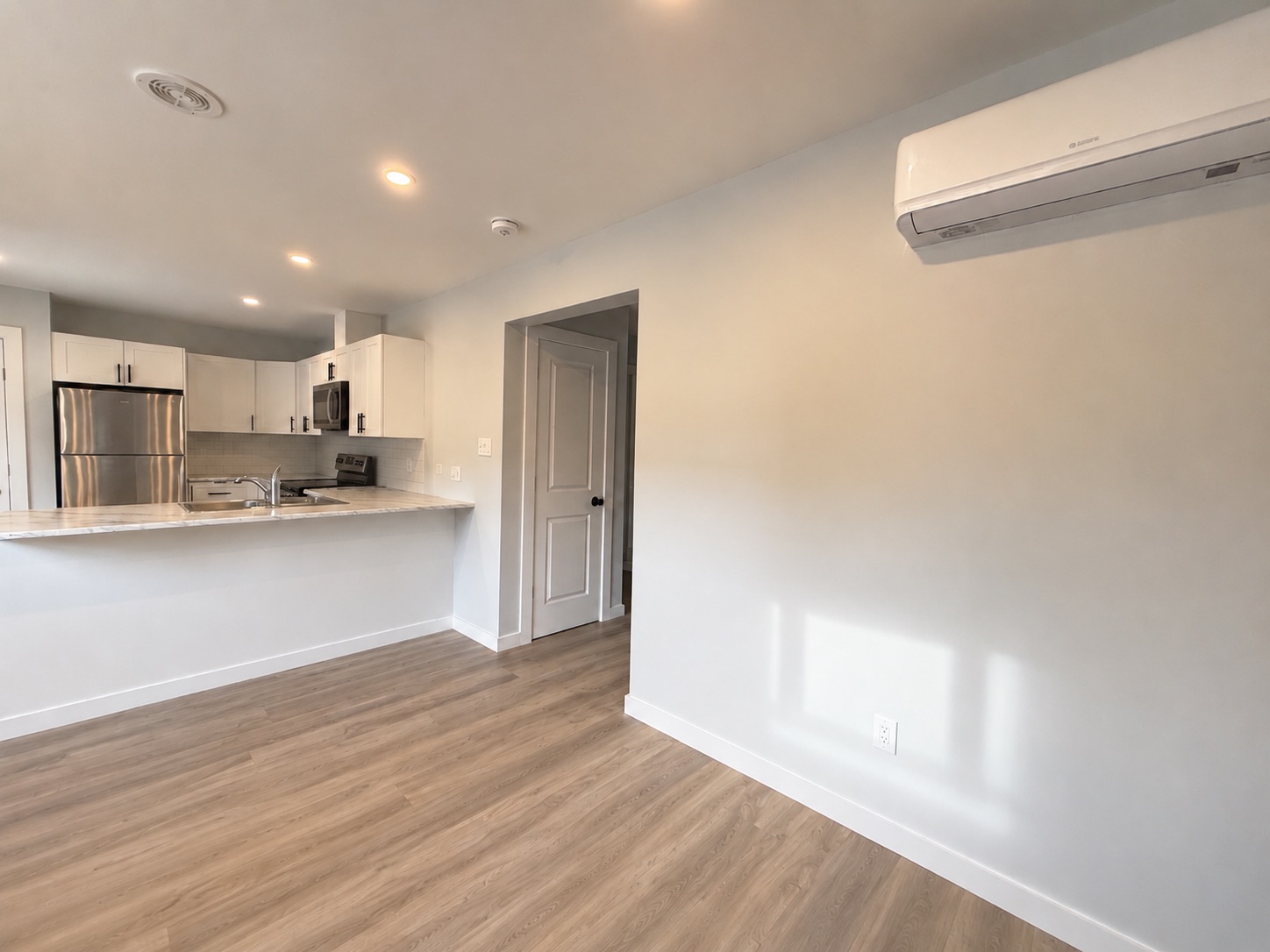 Finished living room of a detached two-bedroom coach home (ADU) built by
  Visture Property Group in Peterborough
