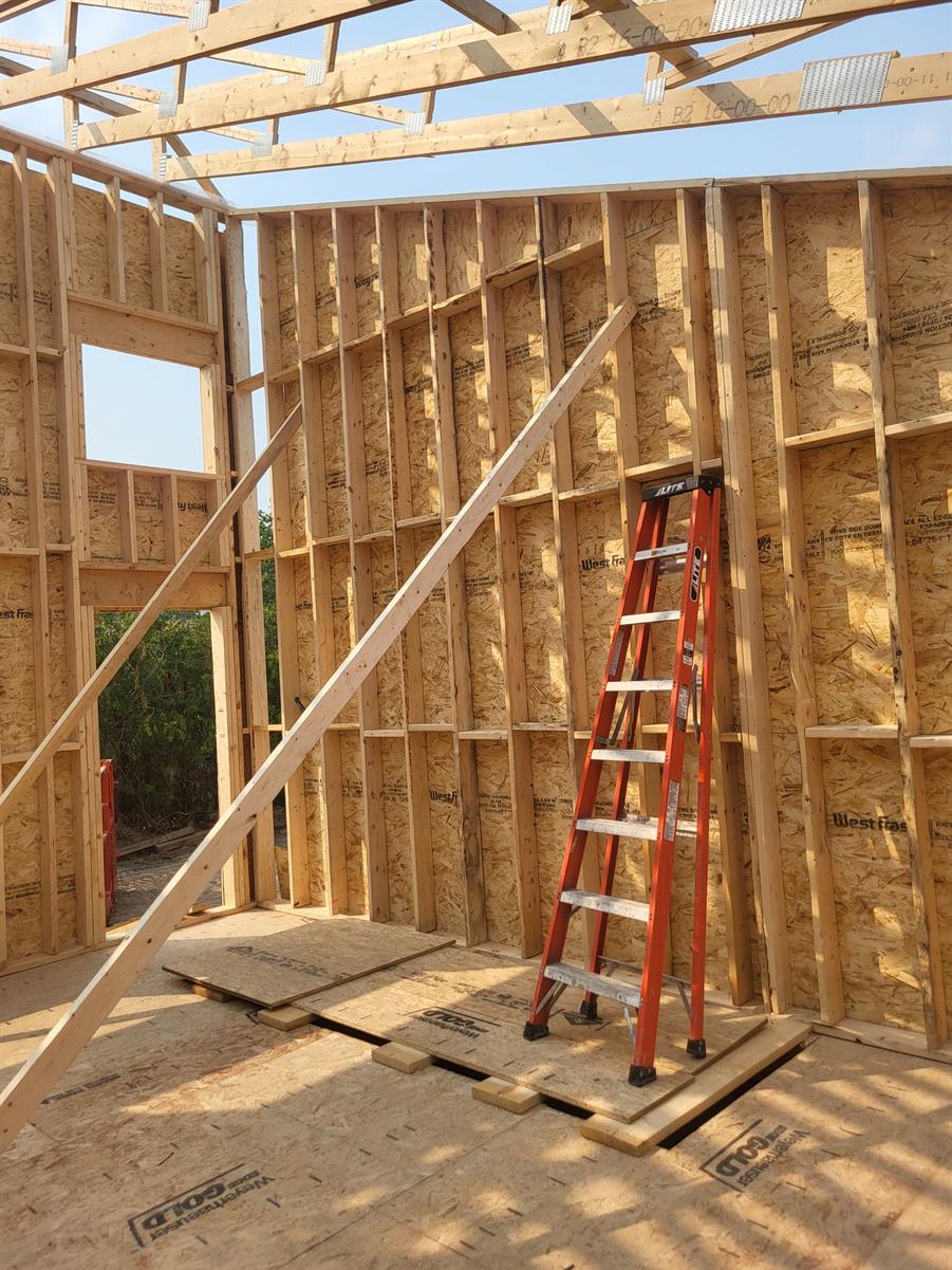 Newly framed walls and roof trusses inside a Visture construction project