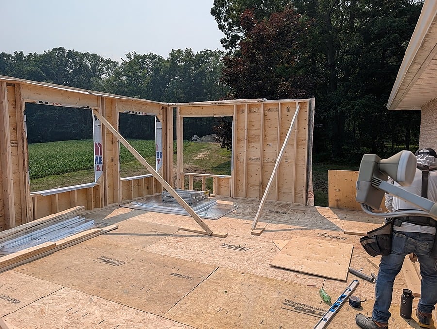 Standing exterior walls during the framing stage of a Visture home addition